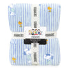 A folded blue and white striped fleece throw blanket with Peanuts character prints, wrapped in a white branded paper band.